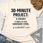 Women's funny woodworking graphic tee shirt for female woodworkers, makers, and DIY builders — Sawdust & Ponytails. Cream t-shirt with "30-MINUTE PROJECT: 6 HOURS, 4 TRIPS TO THE HARDWARE STORE, 1 existential crisis" text.