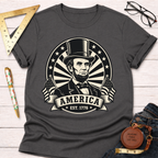 Charcoal gray Abraham Lincoln T-shirt with "America EST. 1776" design, two flags, and stars.
