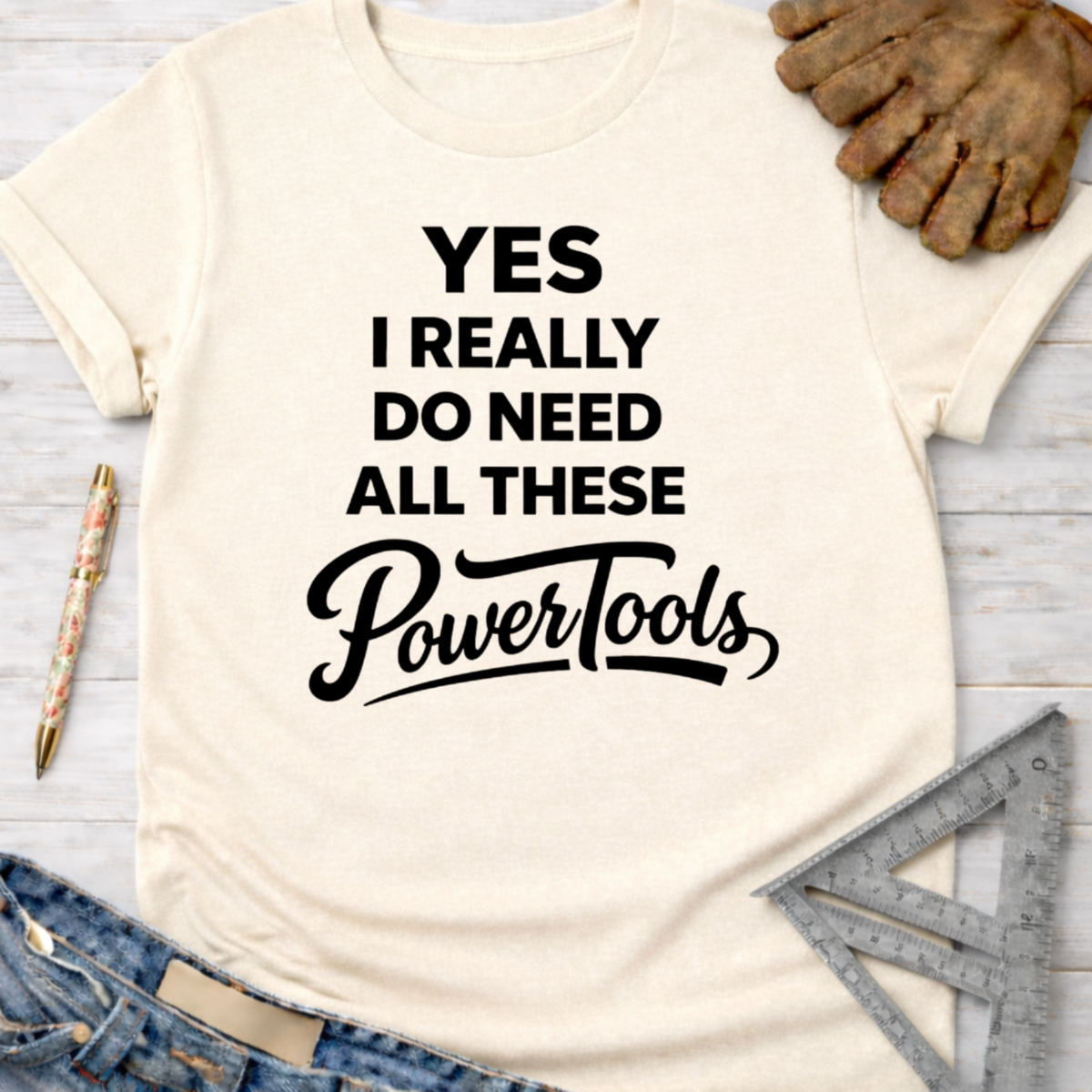 Cream women's funny woodworking graphic tee shirt for female woodworkers, makers, and DIY builders — Sawdust & Ponytails, with "YES I REALLY DO NEED ALL THESE PowerTools" in black text.