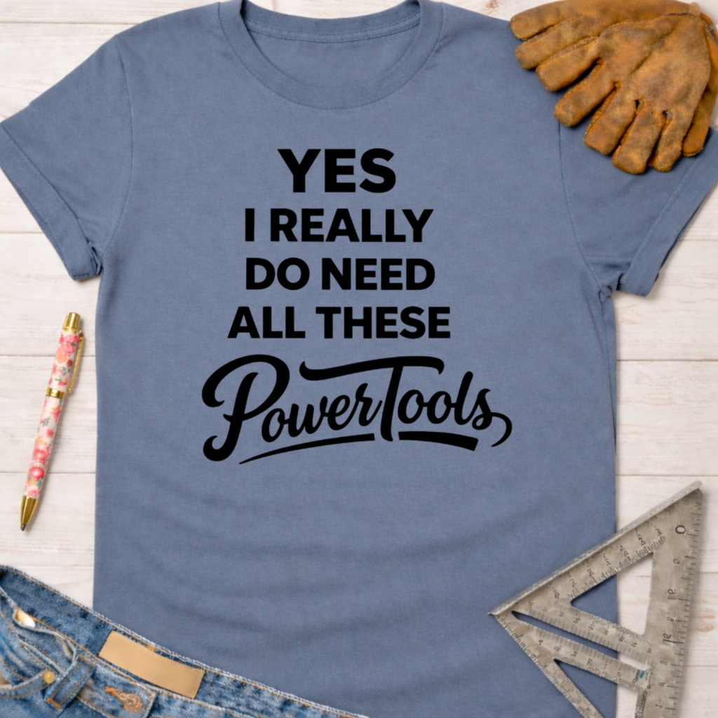 Dusty blue women's tee with "YES I REALLY DO NEED ALL THESE PowerTools" graphic. Women's funny woodworking graphic tee shirt for female woodworkers, makers, and DIY builders — Sawdust & Ponytails