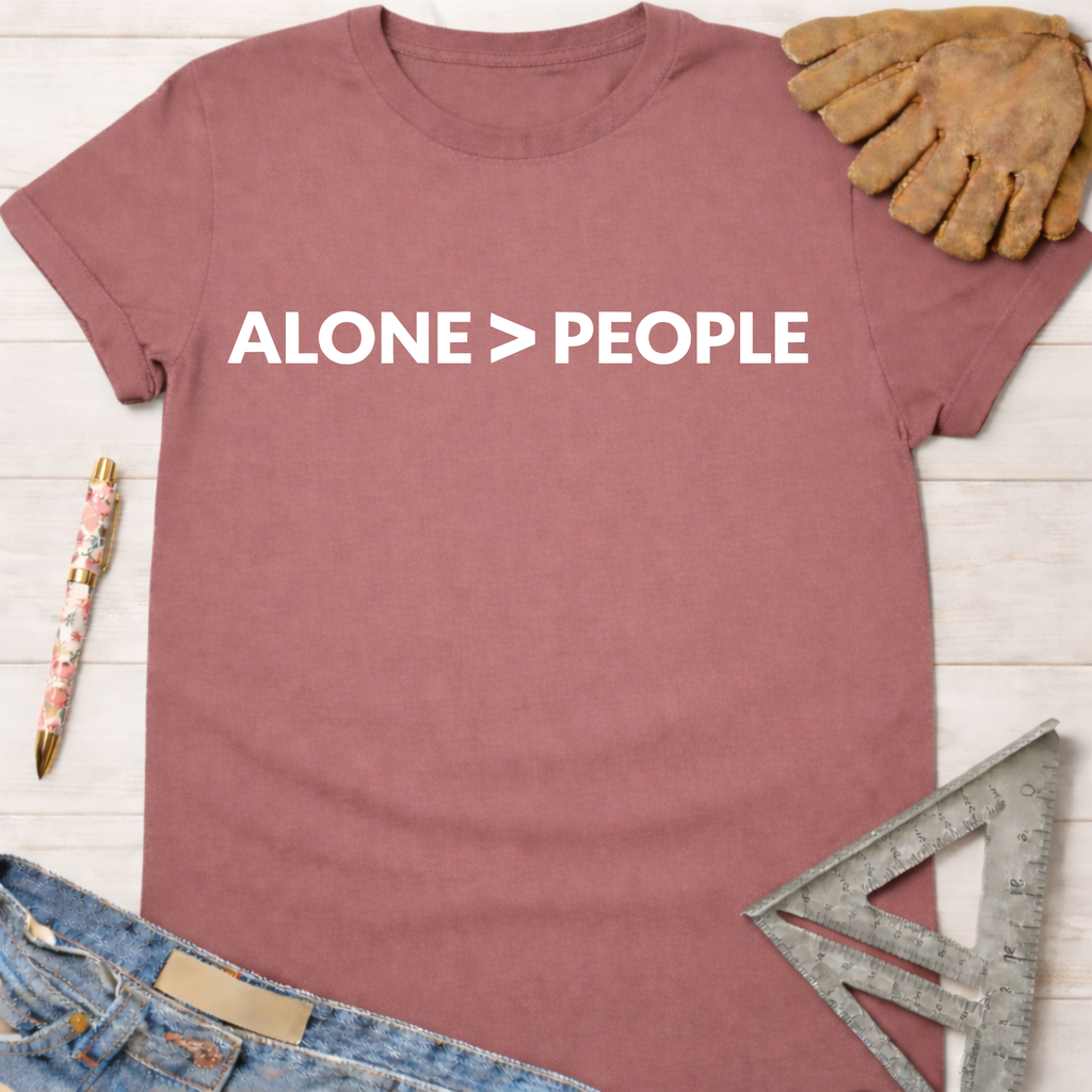 Women's funny woodworking graphic tee shirt for female woodworkers, makers, and DIY builders — Sawdust & Ponytails. Mauve cotton tee with "ALONE > PEOPLE" in white.