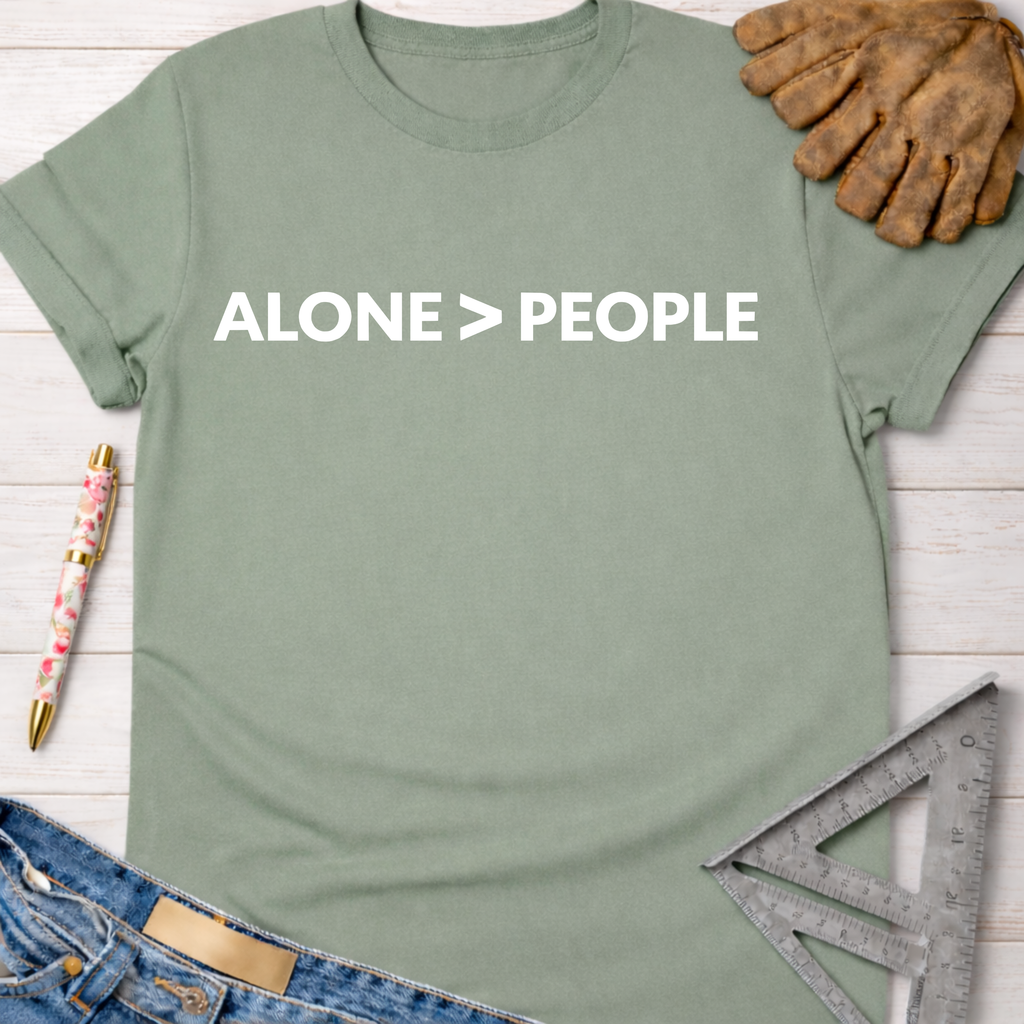 Women's funny woodworking graphic tee shirt for female woodworkers, makers, and DIY builders — Sawdust & Ponytails. Sage green cotton t-shirt with "ALONE > PEOPLE" in white text.