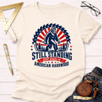 Cream cotton t-shirt with "Still Standing 250 Years of American Hardwood" graphic featuring Bigfoot and an axe.