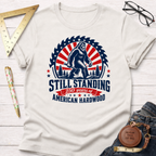 Off-white cotton "Still Standing American Hardwood" graphic tee with Bigfoot holding an axe.