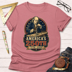 Pink cotton t-shirt with a graphic of Benjamin Franklin drilling wood, "America's 250th 1776-2026".