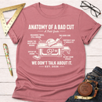 Women's funny woodworking graphic tee shirt for female woodworkers, makers, and DIY builders — Sawdust & Ponytails. Mauve t-shirt with "Anatomy of a Bad Cut" graphic, featuring a table saw diagram.