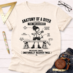 Women's funny woodworking graphic tee shirt for female woodworkers, makers, and DIY builders — Sawdust & Ponytails. Cream t-shirt with "Anatomy of a DIYer: The Measurer" graphic.