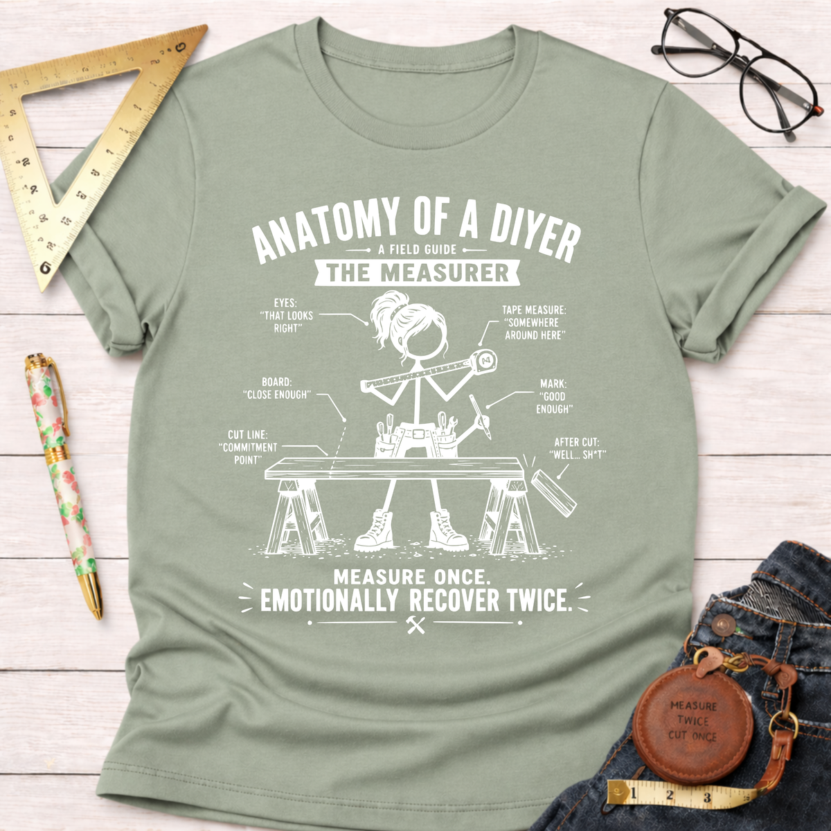 Women's funny woodworking graphic tee shirt for female woodworkers, makers, and DIY builders — Sawdust & Ponytails. Light green cotton t-shirt with "Anatomy of a DIYer The Measurer" graphic.