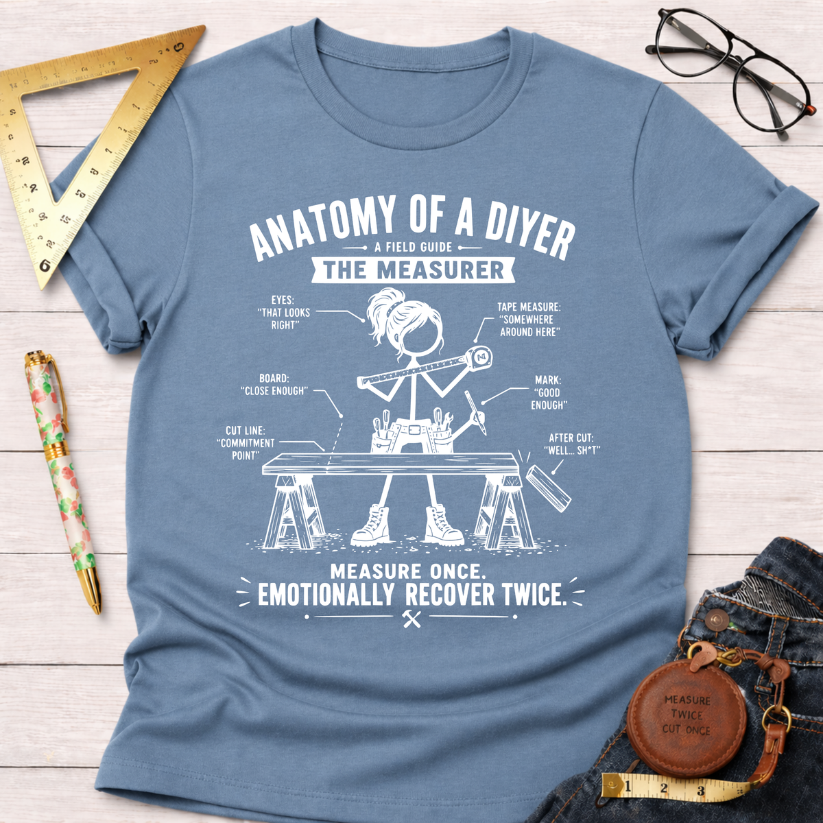 Women's funny woodworking graphic tee shirt for female woodworkers, makers, and DIY builders — Sawdust & Ponytails. Light blue cotton t-shirt with "Anatomy of a DIYer The Measurer" graphic.