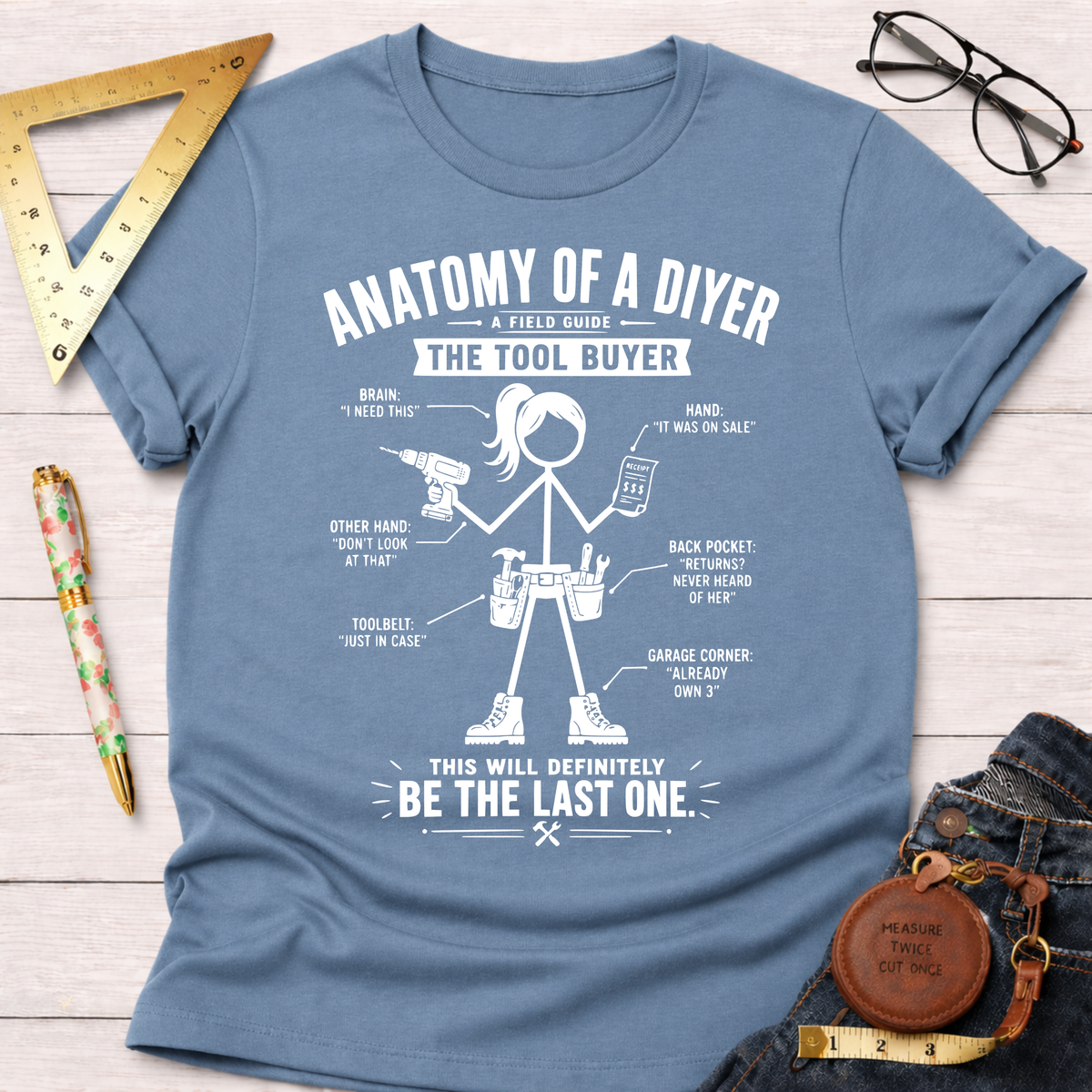 Women's funny woodworking graphic tee shirt for female woodworkers, makers, and DIY builders — Sawdust & Ponytails. Light blue cotton tee with white "Anatomy of a DIYer" graphic.