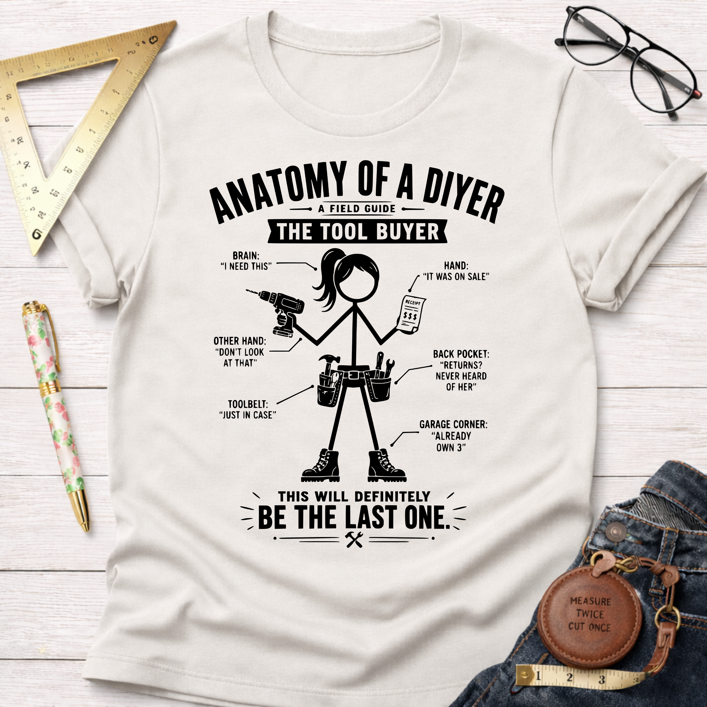 Women's funny woodworking graphic tee shirt for female woodworkers, makers, and DIY builders — Sawdust & Ponytails. White cotton t-shirt with "Anatomy of a DIYer: The Tool Buyer" graphic.