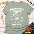 Women's funny woodworking graphic tee shirt for female woodworkers, makers, and DIY builders — Sawdust & Ponytails. Light green crew neck t-shirt with a white graphic of a stick figure DIYer holding tools and text.