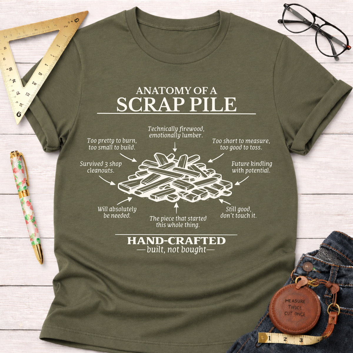 Women's funny woodworking graphic tee shirt for female woodworkers, makers, and DIY builders — Sawdust & Ponytails. Olive green t-shirt with "Anatomy of a Scrap Pile" graphic.