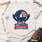 White cotton t-shirt with a patriotic bald eagle and saw blade graphic, "Still Standing 250 Years of American Hardwood" text.