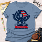 Light blue cotton t-shirt with a patriotic bald eagle and saw blade graphic, "Still Standing 250 Years of American Hardwood" text.