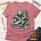 Women's funny woodworking graphic tee shirt for female woodworkers, makers, and DIY builders — Sawdust & Ponytails. Dusty rose cotton t-shirt with a black and white graphic of a bear hand planing wood.