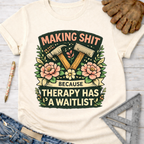 Women's funny woodworking graphic tee shirt for female woodworkers, makers, and DIY builders — Sawdust & Ponytails. Cream t-shirt with "Making Shit Because Therapy Has A Waitlist" graphic featuring hammers and flowers.