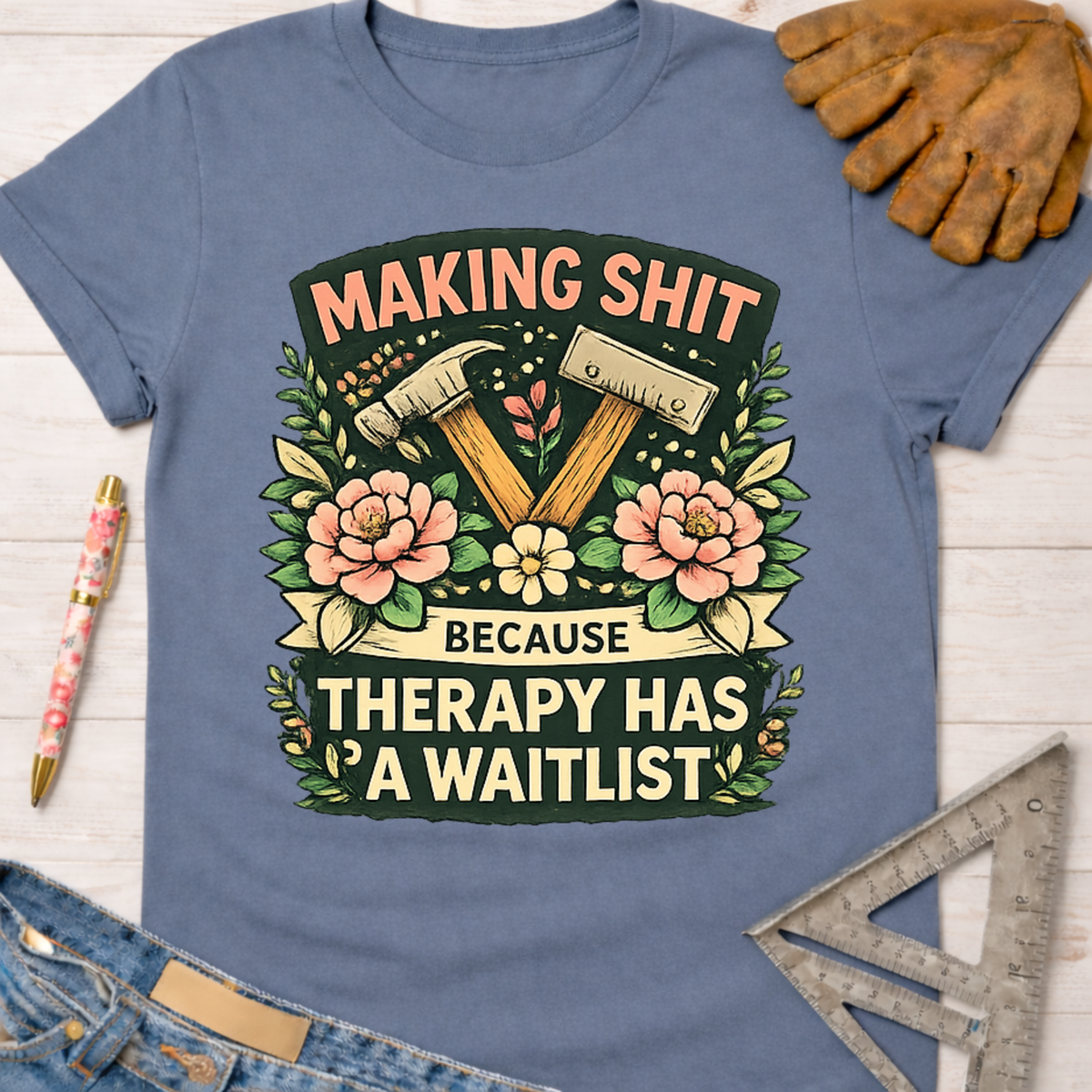 Women's funny woodworking graphic tee shirt for female woodworkers, makers, and DIY builders — Sawdust & Ponytails. Blue cotton tee with "Making Shit Because Therapy Has A Waitlist" graphic.