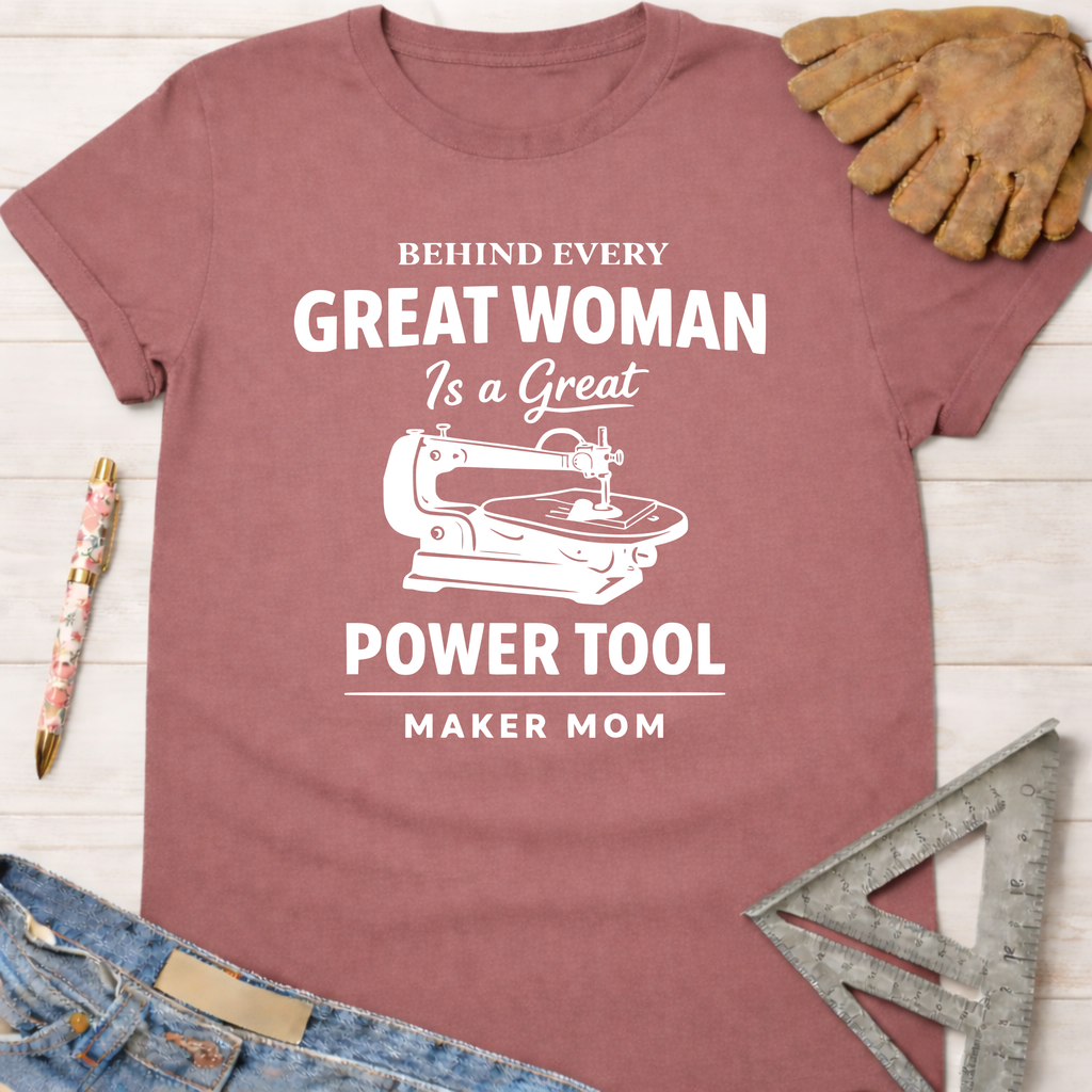 Women's funny woodworking graphic tee shirt for female woodworkers, makers, and DIY builders — Sawdust & Ponytails. Mauve cotton tee with "Behind Every Great Woman Is a Great Power Tool Maker Mom" graphic.