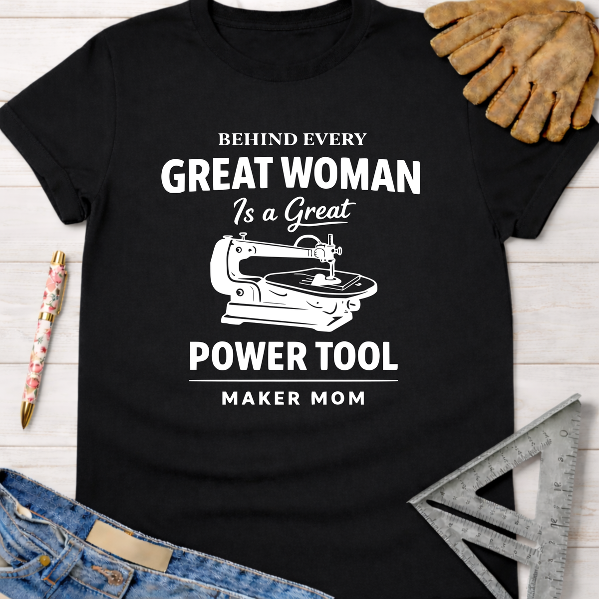 Women's funny woodworking graphic tee shirt for female woodworkers, makers, and DIY builders — Sawdust & Ponytails. Black cotton tee with "Behind Every Great Woman Is a Great Power Tool" graphic.