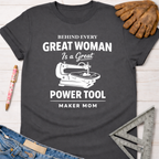 Women's funny woodworking graphic tee shirt for female woodworkers, makers, and DIY builders — Sawdust & Ponytails. Dark gray cotton tee with "Behind Every Great Woman Is a Great Power Tool" and scroll saw graphic.