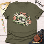 Olive green Bloom & Blade T-shirt with a floral circular saw graphic, laid flat with tools and jeans.