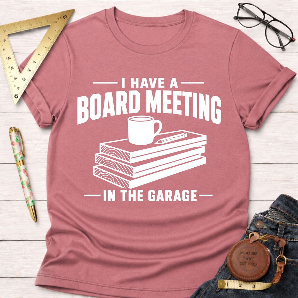 Mauve t-shirt with "I Have A Board Meeting In The Garage" text, wood stack, coffee cup, and pencil graphic.