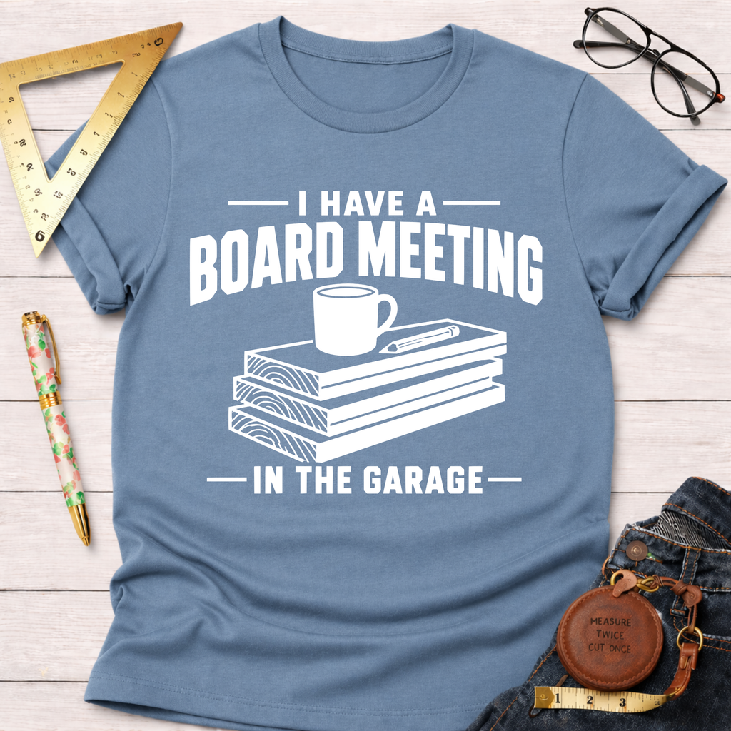 Blue "Board Meeting In The Garage" t-shirt with wood planks, coffee mug, and pencil graphic.