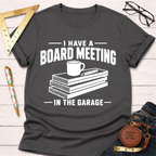 Charcoal gray heather t-shirt with "I Have A Board Meeting In The Garage" text and wood stack graphic.