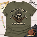 Olive green "Built Different Not Broken" t-shirt with a bearded skull wearing a cap and crossed hammers.