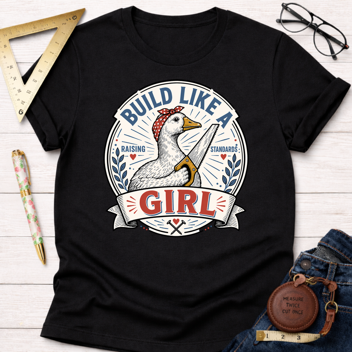 Black cotton "Build Like A Girl" t-shirt with a goose wearing a bandana and holding a saw graphic.