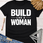 Black cotton "Build Like A Woman" graphic tee, with work gloves, jeans, and a square ruler. Women's funny woodworking graphic tee shirt for female woodworkers, makers, and DIY builders — Sawdust & Ponytails