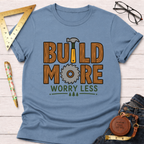 Women's funny woodworking graphic tee shirt for female woodworkers, makers, and DIY builders — Sawdust & Ponytails. Light blue tee with "BUILD MORE WORRY LESS" graphic.