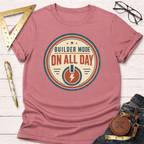 Heather dusty rose t-shirt with "Builder Mode On All Day" graphic, styled with jeans, ruler, and glasses.