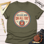 Olive green cotton t-shirt with "Builder Mode On All Day" graphic, styled with jeans and tools.