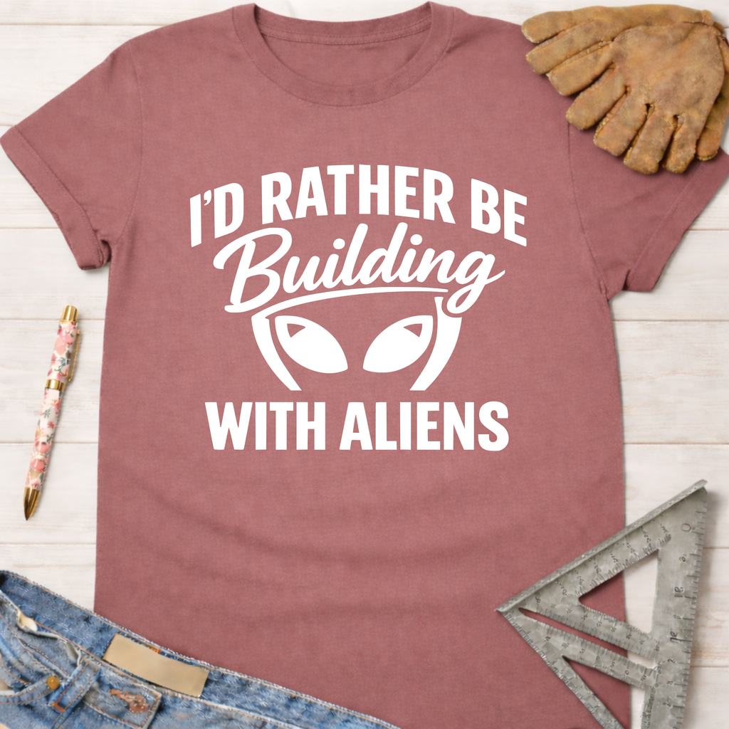 Women's funny woodworking graphic tee shirt for female woodworkers, makers, and DIY builders — Sawdust & Ponytails. Mauve t-shirt with "I'd Rather Be Building With Aliens" graphic.