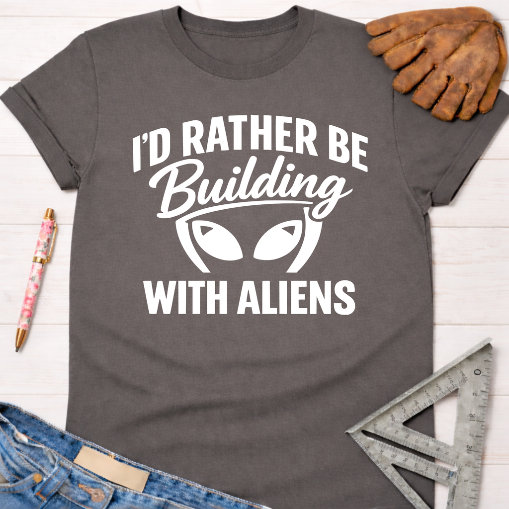 Women's funny woodworking graphic tee shirt for female woodworkers, makers, and DIY builders — Sawdust & Ponytails. Dark gray cotton tee with "I'd Rather Be Building With Aliens" graphic.