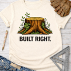 Women's funny woodworking graphic tee shirt for female woodworkers, makers, and DIY builders — Sawdust & Ponytails. Cream t-shirt with a tree stump graphic and "BUILT RIGHT." text.