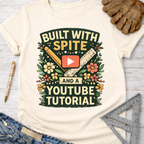 Women's funny woodworking graphic tee shirt for female woodworkers, makers, and DIY builders — Sawdust & Ponytails. Cream t-shirt with "Built With Spite And A YouTube Tutorial" graphic, ruler, pencil, and flowers.