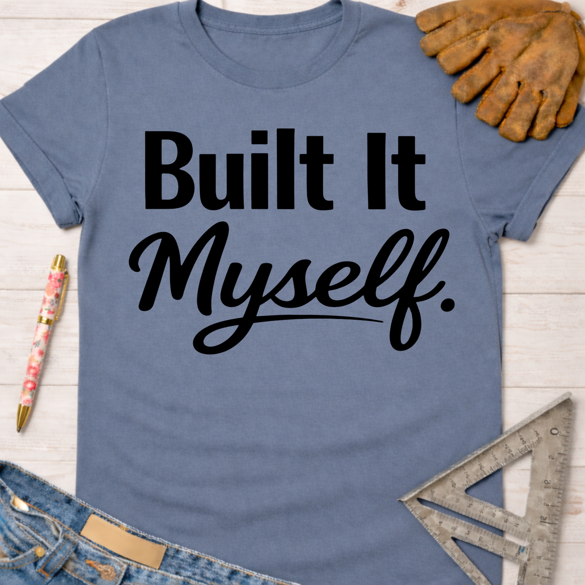 Women's funny woodworking graphic tee shirt for female woodworkers, makers, and DIY builders — Sawdust & Ponytails. Blue short-sleeve t-shirt with "Built It Myself." in black text.