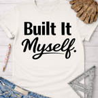 Women's funny woodworking graphic tee shirt for female woodworkers, makers, and DIY builders — Sawdust & Ponytails. Cream t-shirt with "Built It Myself" in black text.