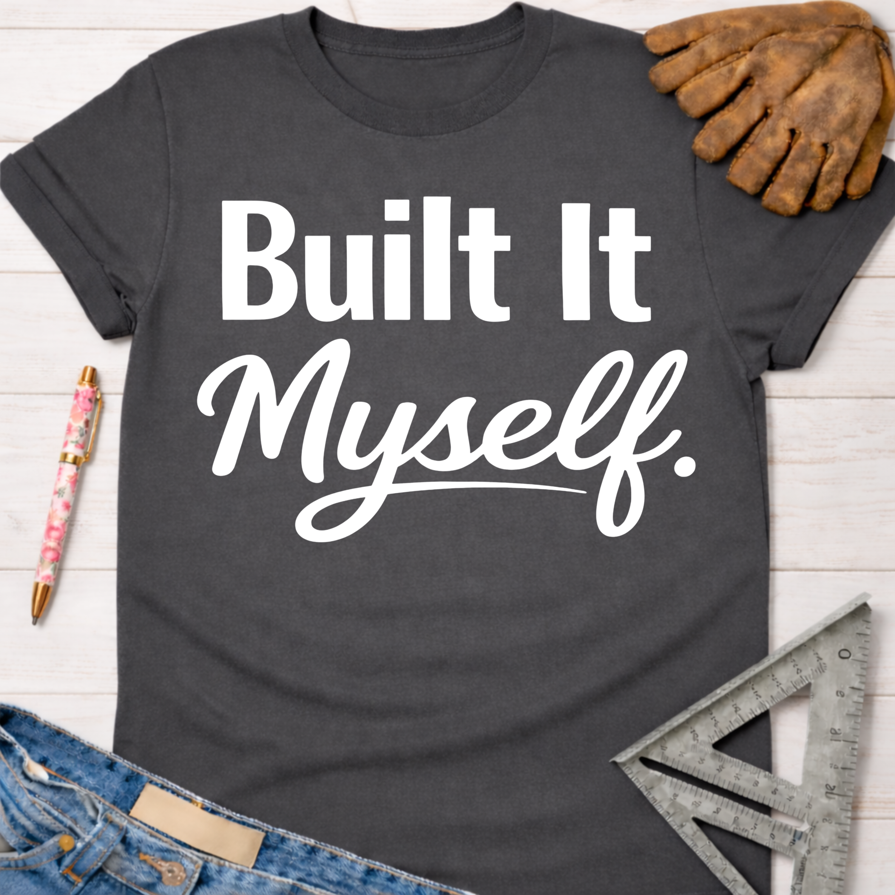 Women's funny woodworking graphic tee shirt for female woodworkers, makers, and DIY builders — Sawdust & Ponytails. Dark gray t-shirt with "Built It Myself." in white text.