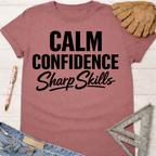 Women's funny woodworking graphic tee shirt for female woodworkers, makers, and DIY builders — Sawdust & Ponytails. Mauve cotton t-shirt with "Calm Confidence Sharp Skills" in black text.