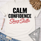 Women's funny woodworking graphic tee shirt for female woodworkers, makers, and DIY builders — Sawdust & Ponytails. White cotton tee with "Calm Confidence Sharp Skills" in black and red text.