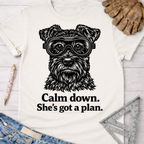 Women's funny woodworking graphic tee shirt for female woodworkers, makers, and DIY builders — Sawdust & Ponytails. White cotton t-shirt with a black schnauzer wearing safety goggles and "Calm down. She's got a plan." text.