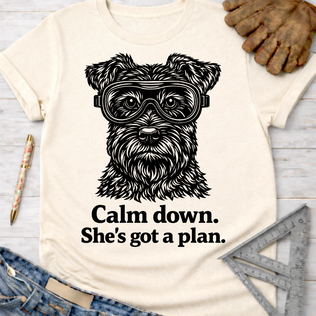 Women's funny woodworking graphic tee shirt for female woodworkers, makers, and DIY builders — Sawdust & Ponytails. Cream t-shirt with a black graphic of a dog wearing safety goggles and the text "Calm down. She's got a plan.