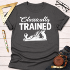 Women's funny woodworking graphic tee shirt for female woodworkers, makers, and DIY builders — Sawdust & Ponytails. Dark gray cotton tee with "Classically Trained" and a hand plane graphic.