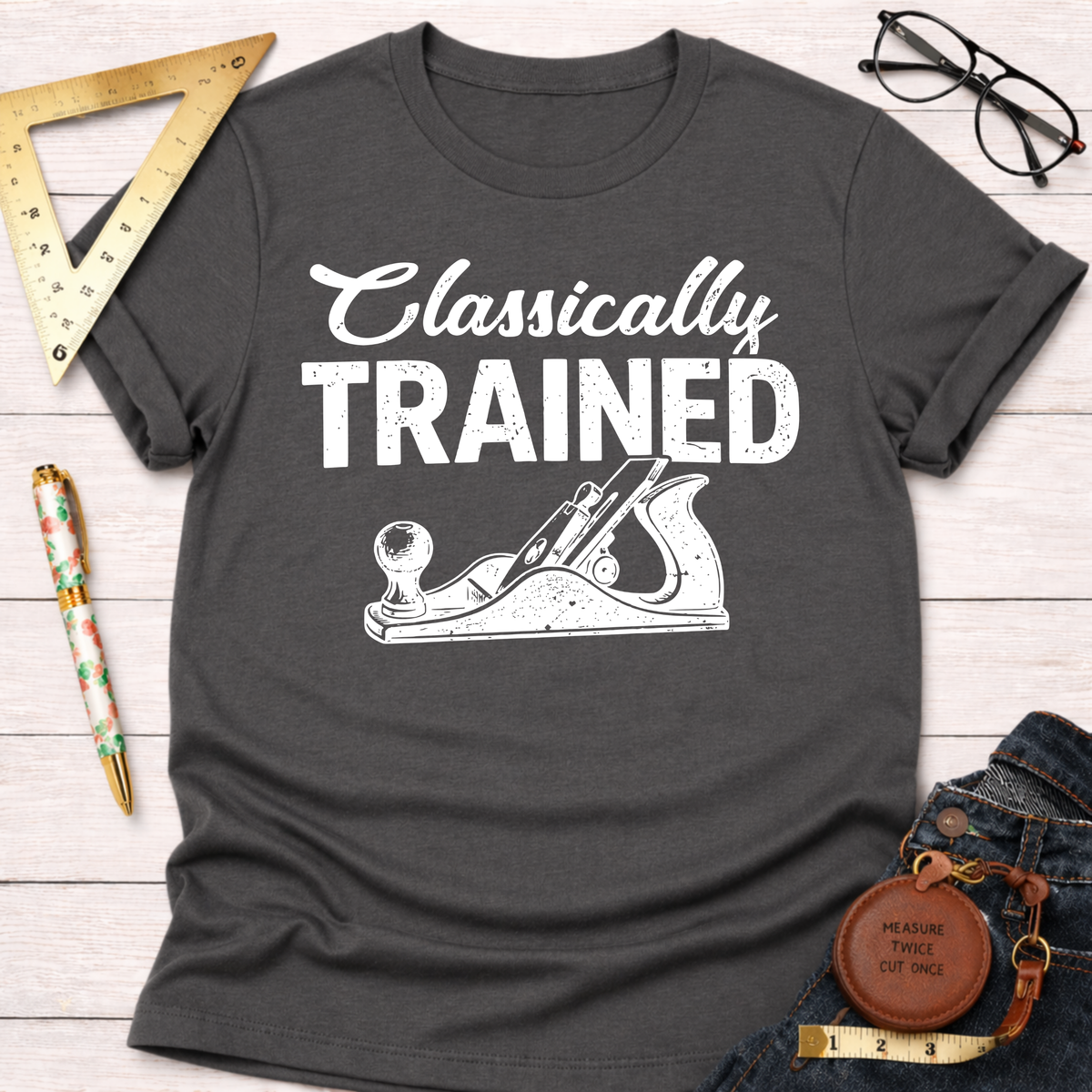 Women's funny woodworking graphic tee shirt for female woodworkers, makers, and DIY builders — Sawdust & Ponytails. Dark gray cotton tee with "Classically Trained" and a hand plane graphic.
