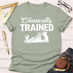 Women's funny woodworking graphic tee shirt for female woodworkers, makers, and DIY builders — Sawdust & Ponytails. Sage green cotton tee with "Classically Trained" and hand plane graphic.