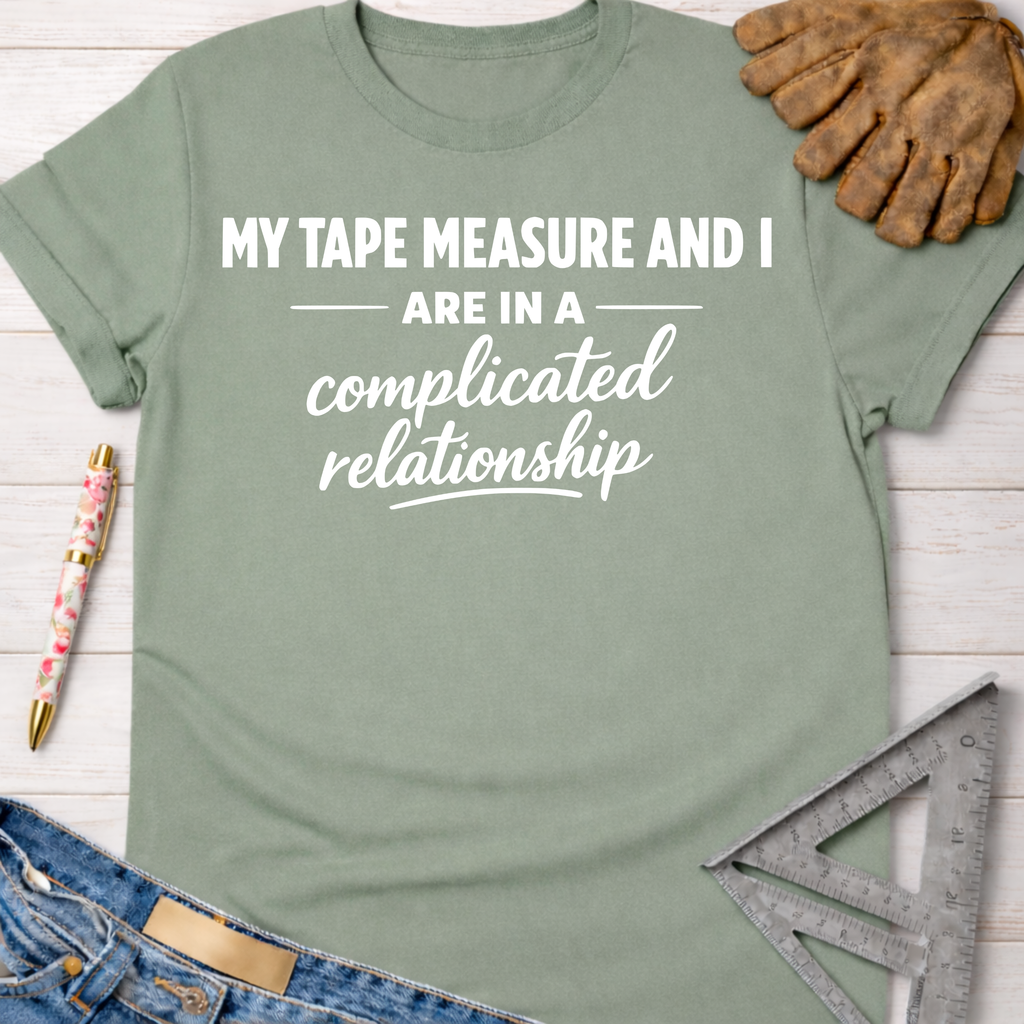 Sage green cotton tee with "MY TAPE MEASURE AND I ARE IN A complicated relationship" text. Women's funny woodworking graphic tee shirt for female woodworkers, makers, and DIY builders — Sawdust & Ponytails